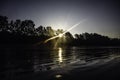 The first light of the day - The light from the sun shines through the trees in the morning at the beach