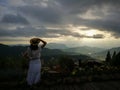 First light of day and the woman breathe fresh air , watching sunshine and mist on top of the mountain. Mountain with The fog