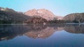First light on the lake with mountains reflection Royalty Free Stock Photo