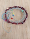 First nations dreamcatcher in the process of being made with sinew and beads on a wood background