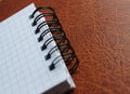 First Page Of Spiral Checkered Notebook On Expensive Leather Macro Shot Photo Royalty Free Stock Photo