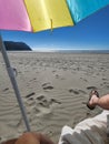 First person beach vacation under umbrella