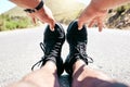 First person fit young mixed race man stretching before his exercise outdoors. Closeup male warming up and getting ready