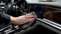 First-person View of Hands Cleaning Luxury Car Dashboard with Microfiber Cloth Royalty Free Stock Photo
