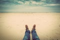 First person perspective of man legs in jeans on the autumn beach