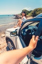 first person point of view man closing door of the car woman sitting on the hood