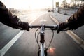 First-person view of cyclist in the city at morning