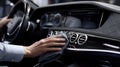 First-person View of Hands Cleaning Luxury Car Dashboard with Microfiber Cloth Royalty Free Stock Photo