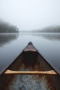 first person view of kayak boat at mountain lake with fog, pov canoe at misty river Royalty Free Stock Photo