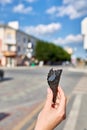 A first person view, a person walking along the road with an ice cream in his hands, shallow depth of field, vertical.