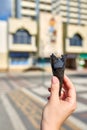 A first person view, a person walking along the road with an ice cream in his hands, shallow depth of field, vertical.