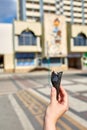 A first person view, a person walking along the road with an ice cream in his hands, shallow depth of field, vertical.