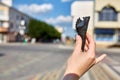 A first person view, a person walking along the road with an ice cream in his hands, shallow depth of field, vertical.