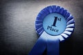 First place award rosette with ribbons and copy space Royalty Free Stock Photo