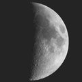 First quarter moon seen with telescope in black and white Royalty Free Stock Photo