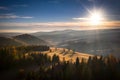 The first rays of the rising sun over the autumnal Tatra Mountains. The pass over Lapszanka. Poland