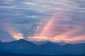First rays rising sun over dark blue morning Alps mountains Royalty Free Stock Photo