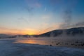 First rays of the sun over the winter river