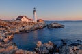 The first rays of sunrise hits the Maine Coast turning the Rocks