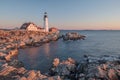 The first rays of sunrise hits the Maine Coast turning the Rocks