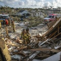 First responders in action: firefighters and emts at a tornado disaster site Royalty Free Stock Photo