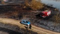 First Responders at the place of wildfire - aerial shot of burned meadow and forest