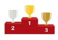 First, second and third place. Award for victory: gold, silver and copper. Cup winners on the red pedestal Royalty Free Stock Photo