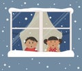 First snow. Children looks at the snow through the window