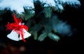 Christmas bells on a snow-covered branch of a juniper. Selective focus Royalty Free Stock Photo