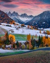 First snow fallen on green hills on Santa Magdalena village with Seceda peak. Royalty Free Stock Photo