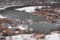 First snow fell on dry grass on banks of river Royalty Free Stock Photo