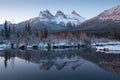 First snow Almost near perfect reflection of the Three Sisters Peaks in the Bow River. Canmore in Banff National Park Canada Royalty Free Stock Photo