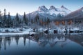 First snow Almost near perfect reflection of the Three Sisters Peaks in the Bow River. Canmore in Banff National Park Canada Royalty Free Stock Photo