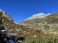 First snow on the rocky mountain peak Fluela Wisshorn (3085 m) in the Swiss Alps and above the mountain road pass Fluela Royalty Free Stock Photo