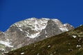 First snow on the rocky mountain peak Fluela Wisshorn (3085 m) in the Swiss Alps and above the mountain road pass Fluela Royalty Free Stock Photo