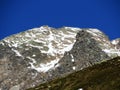 First snow on the rocky mountain peak Fluela Wisshorn (3085 m) in the Swiss Alps and above the mountain road pass Fluela Royalty Free Stock Photo