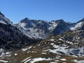 First snow on the rocky mountain peaks Augstenhuereli (3027 m) and Leidhorn (2932 m) in the Albula Alps