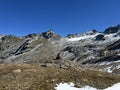 First snow on the rocky mountain peaks Piz Sarsura Pitschen (3132 m) and Piz Sarsura (3176 m) Royalty Free Stock Photo