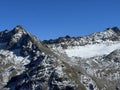 First snow on the rocky mountain peaks Piz Sarsura Pitschen (3132 m) and Piz Sarsura (3176 m) Royalty Free Stock Photo