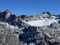 First snow on the rocky mountain peaks Piz Sarsura Pitschen (3132 m) and Piz Sarsura (3176 m) Royalty Free Stock Photo