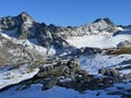 First snow on the rocky mountain peaks Piz Sarsura Pitschen (3132 m) and Piz Sarsura (3176 m) Royalty Free Stock Photo