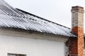 The first snow on the roof of a village house is autumn frosts. Royalty Free Stock Photo