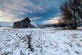 First snow of winter blankets an old wood barn on an Idaho farm