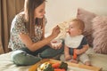 First solid food for young kid. Fresh organic carrot for vegetable lunch. Baby weaning.