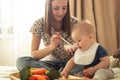 First solid food for young kid. Fresh organic carrot for vegetable lunch. Baby weaning. Royalty Free Stock Photo