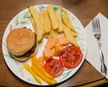 First spring dinner, burgers, fries, melon, tomatoes and peppers