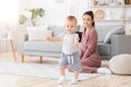 First Steps. Adorable smiling baby boy learning how to walk at home, Royalty Free Stock Photo