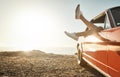 First stopfun. a womans legs hanging out a car window while on a road trip. Royalty Free Stock Photo