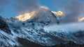 First sunbeams lighting the peak of Mount Annapurna South on sunrise, Annapurna Conservation Area, Himalaya, Nepal. Royalty Free Stock Photo