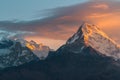 First sunbeams lighting the peak of Mount Annapurna South on sunrise, Annapurna Conservation Area, Himalaya, Nepal. Royalty Free Stock Photo